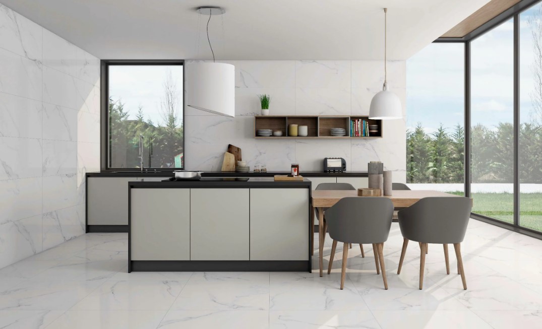 Cozinha moderna com ilha central, mesa de jantar e iluminação elegante.